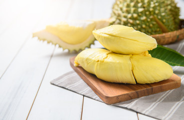 Fresh durian (monthong) on sack and white wood background,
