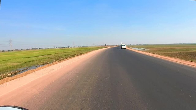 tarmac road clip with amazing blue sky taken form fast moving vehicle