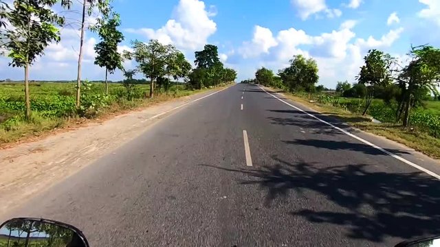 motorcycle ridding on tarmac road with amazing blue sky and cloud patch