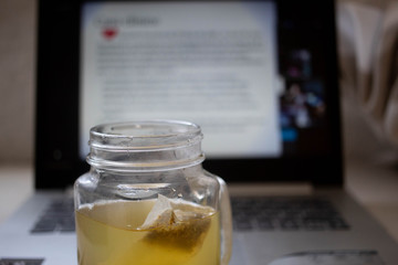 jar of tea and a laptop
