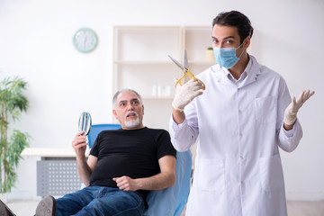 Old man visiting young doctor for plastic surgery