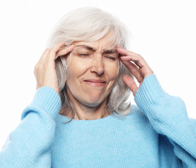 health and people concept: senior lady having headache over white background