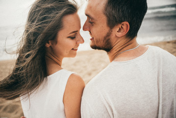
Happy lovers have a cheerful vibes on sea beach at sunset 
