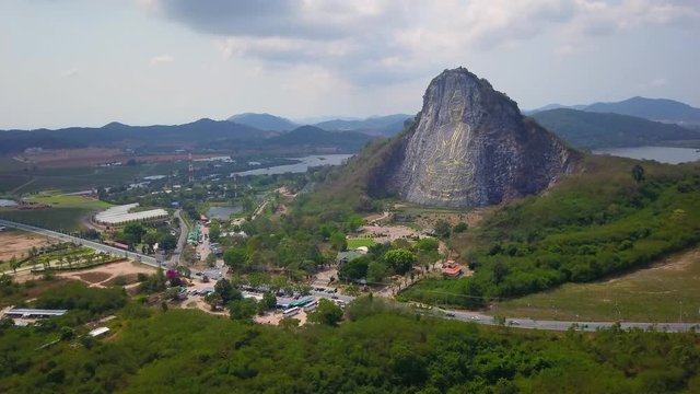 Aerial drone view of carved buddha image from gold on the cliff at Khao Chee chan, Pattaya, Thailand