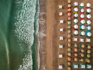 Fototapeten Tropischer Strand Aerial view of amazing beach with umbrellas and turquoise sea at sunrise. Black Sea at Vama Veche, Romania  © danmir12