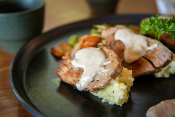 Fish dish with red tuna steak with mashed potatoes and grilled vegetables.