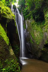Tropical landscape. Waterfall in hidden canyon. Travel and adventure concept. Soft focus. Slow...