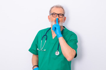 doctor with expression of silence isolated on white wall