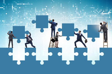 Businessman in teamwork concept with jigsaw puzzle