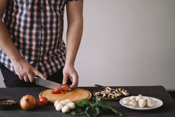 Diet concept, healthy lifestyle, low calorie food. Closeup portrait of man cooking healthy dinner of vegetables and mushrooms