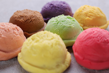 Various flavored ice cream scoops, close up. Food background, refreshment, rainbow, variety, cool seasonal sweets, refreshment concept