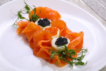 Sliced salmon with caviar