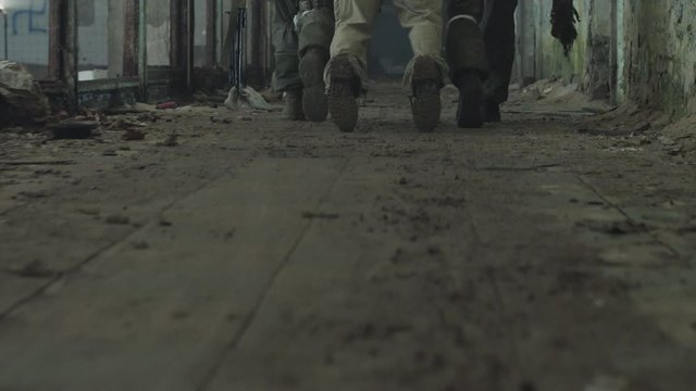 Terrorist is catching a soldier as a hostage.