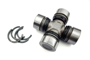 Cross of a cardan shaft of a car with circlips on a white background.  Spare parts.