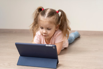 Little child girl using tablet pc