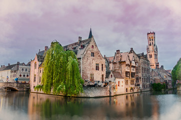 Watercolor painting effect of photo with view on Bruges old town and Belfry tower with pink sky during twilight, Bruges, Belgium. Watercolor illustration of view from famous viewpoint in Bruges.