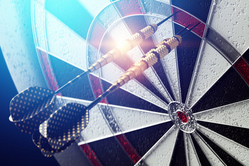 Darts, a golden dart stuck in a target. Dartboard is the target and goal. Business getting into the target audience. 3D illustration, 3D rendering, copy space.