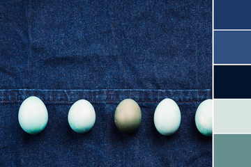 Colorful blue boiled easter eggs on jeans apron background. Monochrome color swatch