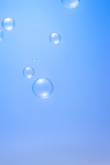 Transparent soap bubbles isolated on blue background