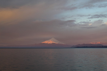 Fototapeta na wymiar Al pie del volcán, en una hermosa puesta de sol. Puerto Varas, Chile. 