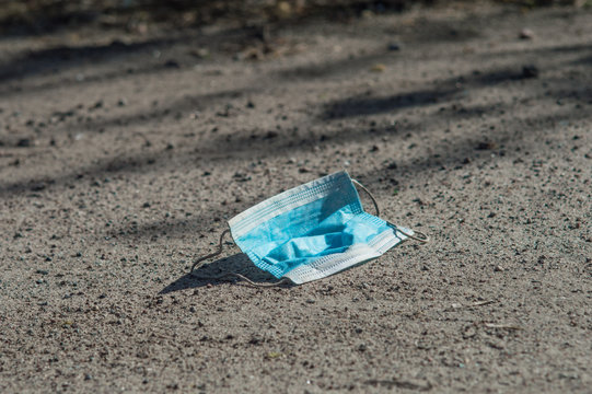 Blue Medical Mask On The Ground