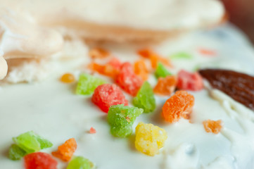 Confectionery multi-colored decorative topping on icing cake.