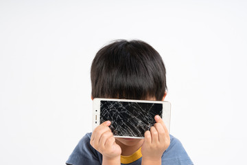 Asian boy holding mobile phone with broken screen glass
