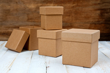 Cardboard boxes of different sizes with lids. Background for gift wrapping. Products from natural materials.
