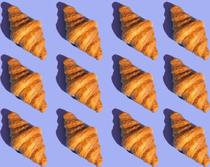 Bakery products pattern with baked croissant. Purple background, top view. Pop art style. Delicious and food concept.