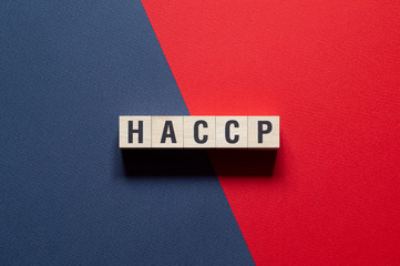 HACCP - Hazard Analysis and Critical Control Points word concept on cubes