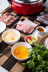 Sukiyaki . Preparation of raw materials,beef,egg ,tofu,vegetable and mung bean noodle  for sukiyaki using hot pots.