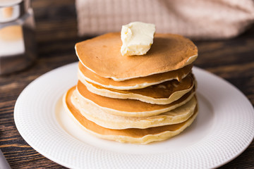 Pile of tasty pancakes with butter. Breakfast concept.