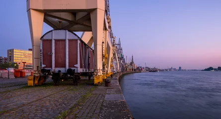 Schilderijen op glas Historical harbor cranes in the old section of the Port of Antwerp. © Erik_AJV