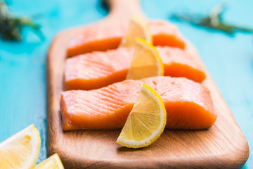 Fresh raw salmon on wooden cutting board.