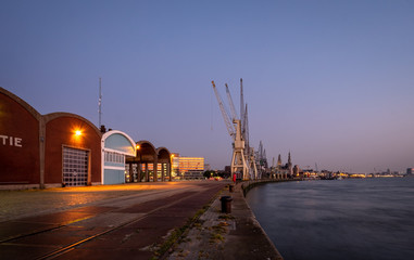 Antwerp, Belgium - 26 April 2020: Historical harbor cranes in the old section of the Port of Antwerp.