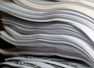 Stack of sheets of paper documents in soft focus close up macro