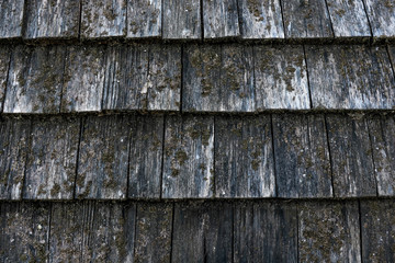 Texture of wooden roof. Shingle aged wooden background.