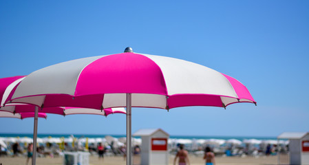 beach umbrellas open in front of the sea