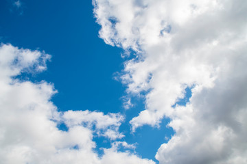 Naklejka na ściany i meble Background with blue sky with lots of white clouds