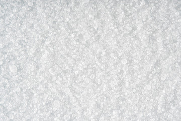 Light background of sprinkled salt at high magnification