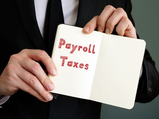 Business concept meaning Payroll Taxes with phrase on the page.