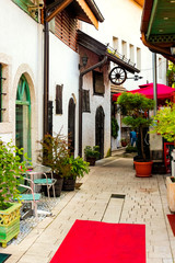 Fototapeta na wymiar Street cafe on a narrow street in the old town of Street cafe in the old city of Sarajevo, Bosnia and Herzegovina