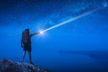 Man hiker with backpack at night