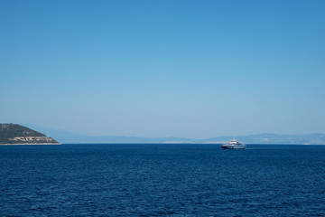 Fototapeta na wymiar Aegean sea coast in Greece, passenger ship