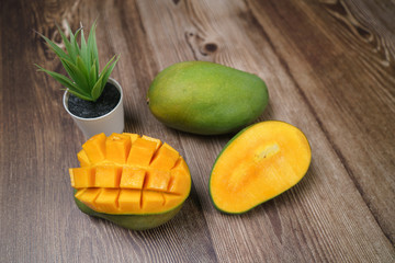 Close up of famous sweet mango in North Malaysia called Harum Manis isolated on top of dark wooden background. Sweet and juicy. Malaysian and Asian favourite mango.