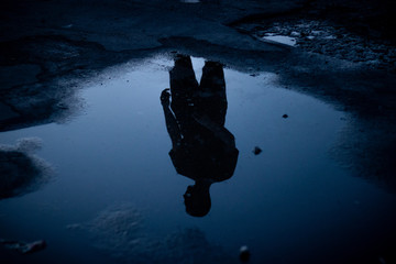 silhouette of a man standing on the water