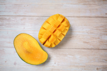 Close up of famous sweet mango in North Malaysia called Harum Manis isolated on top of wooden background. Sweet and juicy. Malaysian and Asian favourite mango.