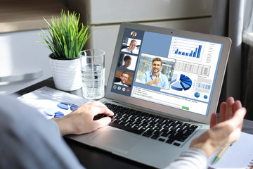Business woman talking to her colleagues in video conference. Multiethnic business team working...