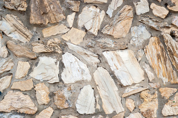 Part of a real wall made of rustic clear and brown bricks Background texture
