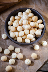 Macadamia nuts on wooden background